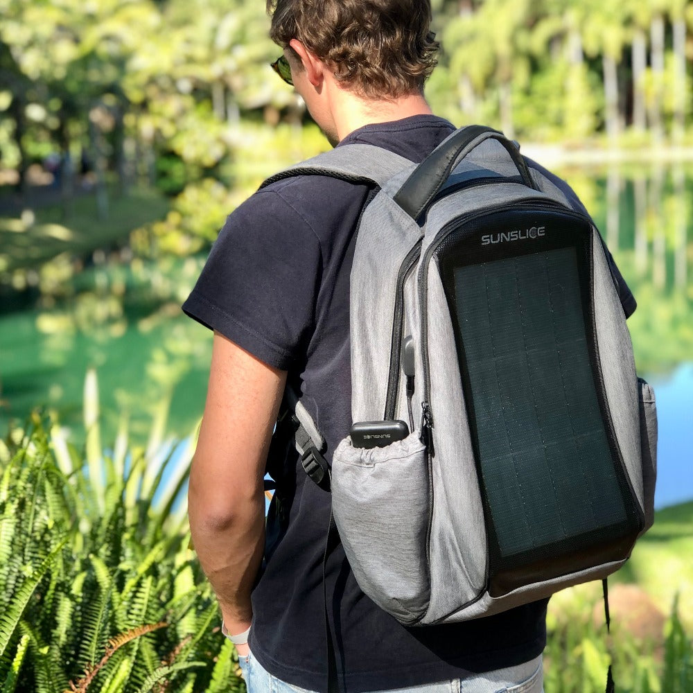 a man with portable backpack and its solar panel for camper
