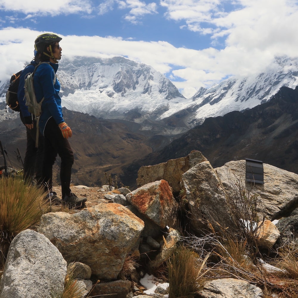two hikers resting on a mountaintop to recharge an Electron in the sunlight