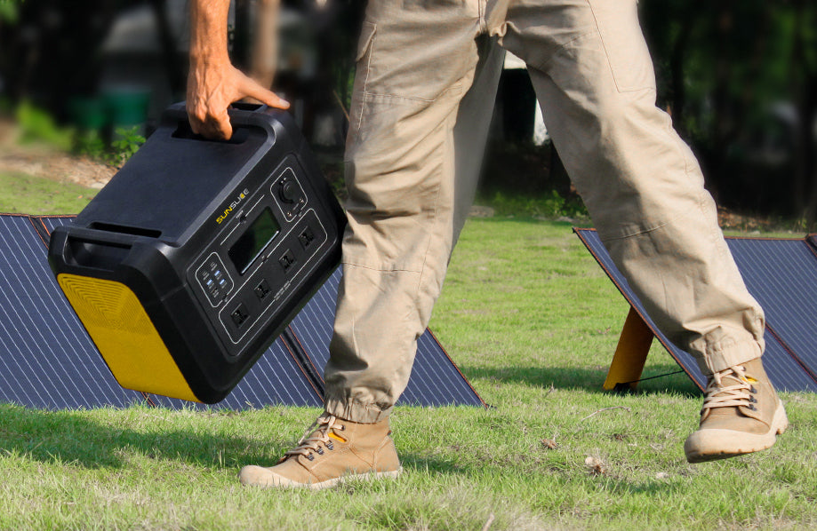 generator gravity with its compact solar panel carried by a man on sunny ground