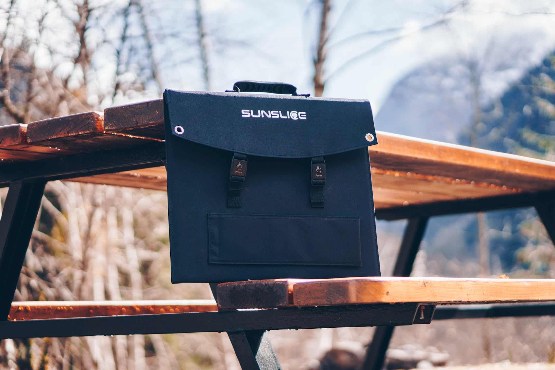 a Fusion40 foldable solar panel on a camping table in autumn