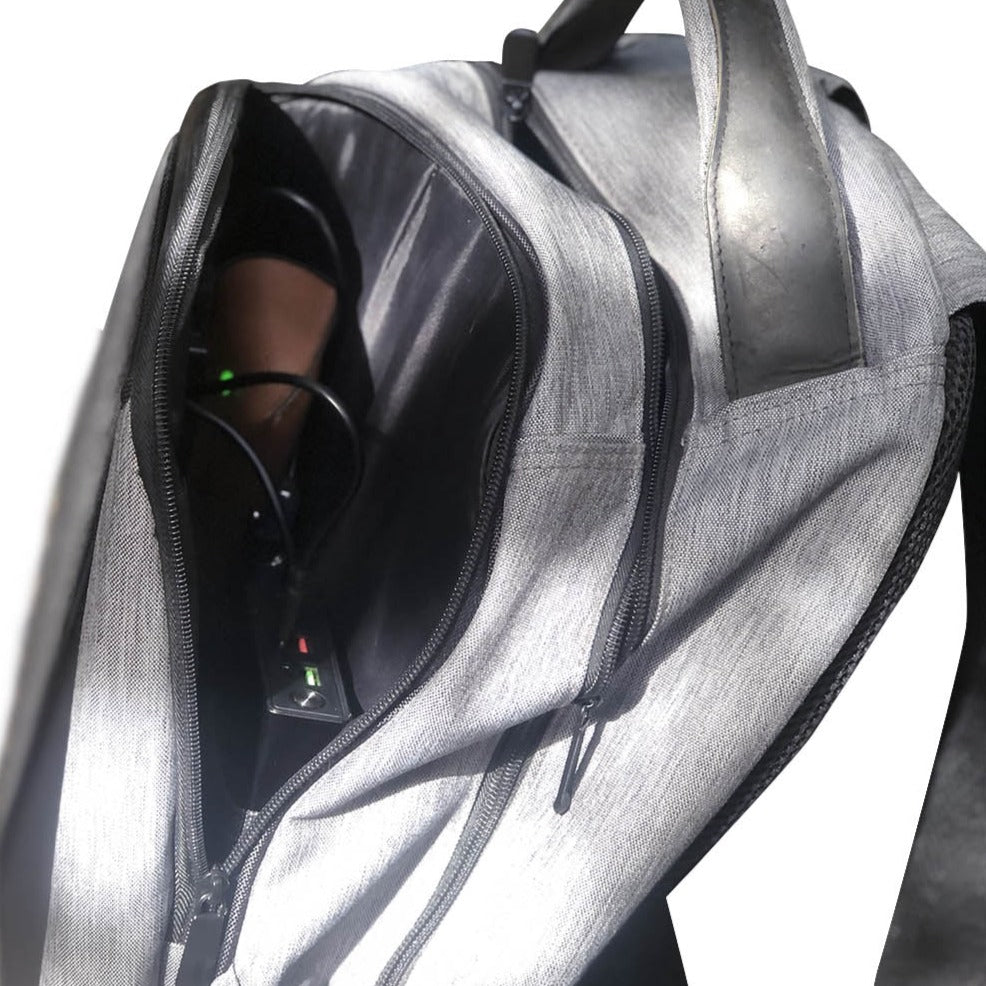 photo of a grey backpack Zenith with solar panels and Powerbank inside on a white background