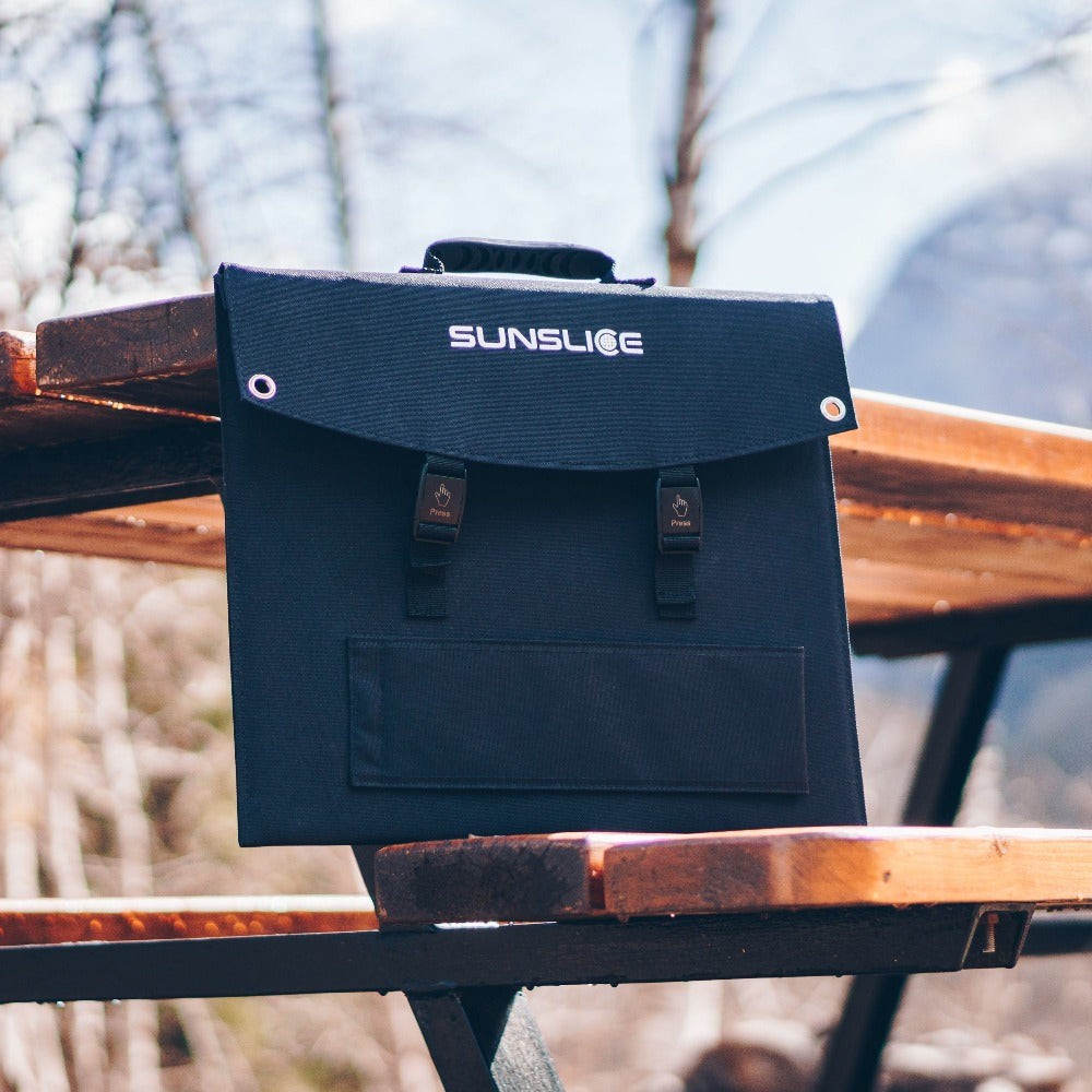 portable solar panel for camping on a table in the middle of the forest