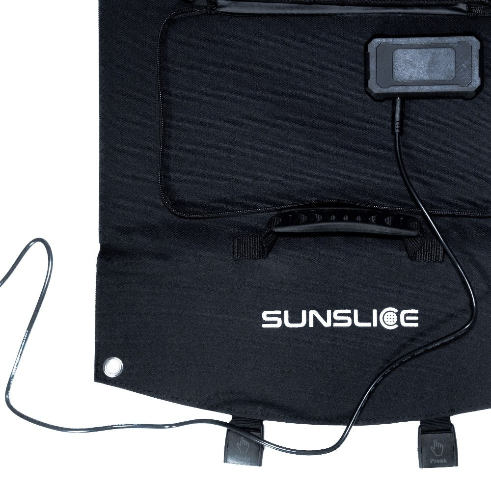 photo zoomed in on the USB port of a compact solar panel with the jack plug connected
