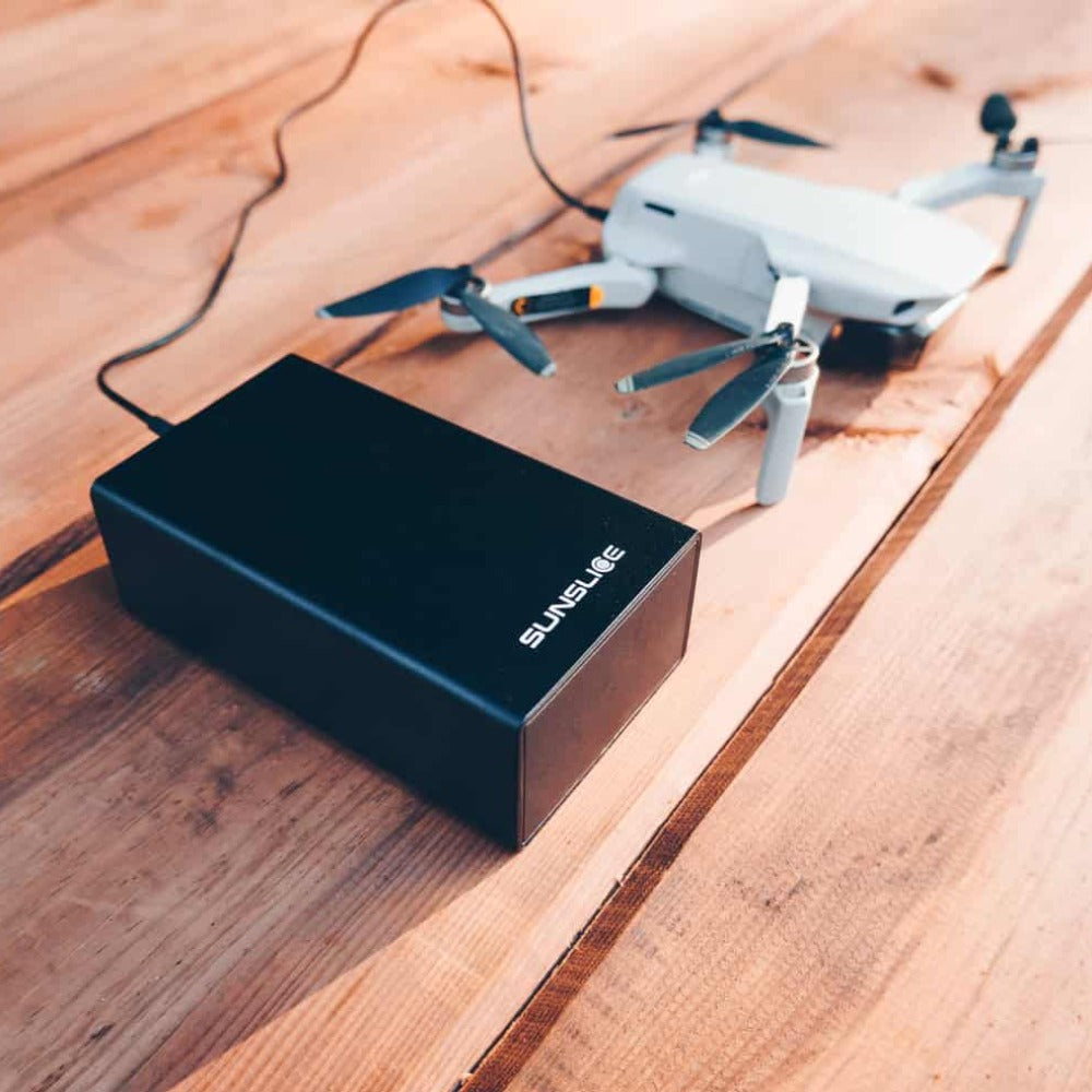 gravity40 external battery 100 w power bank loading a drone on a table