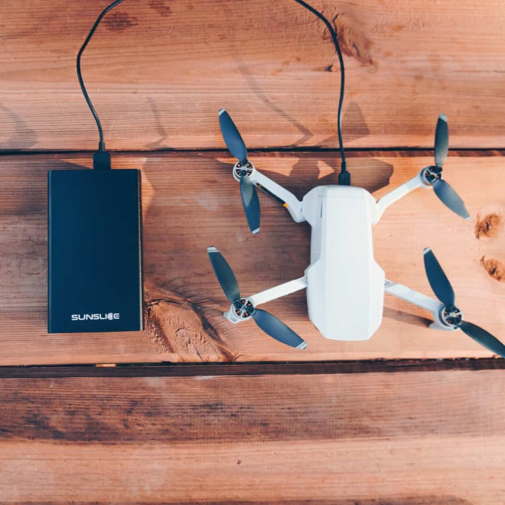 gravity40 portable laptop charger loading a drone from the top