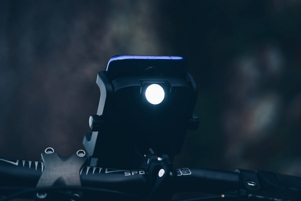 Photo of a handlebar-mounted Cyclotron taken in the middle of the night with its flashlight on