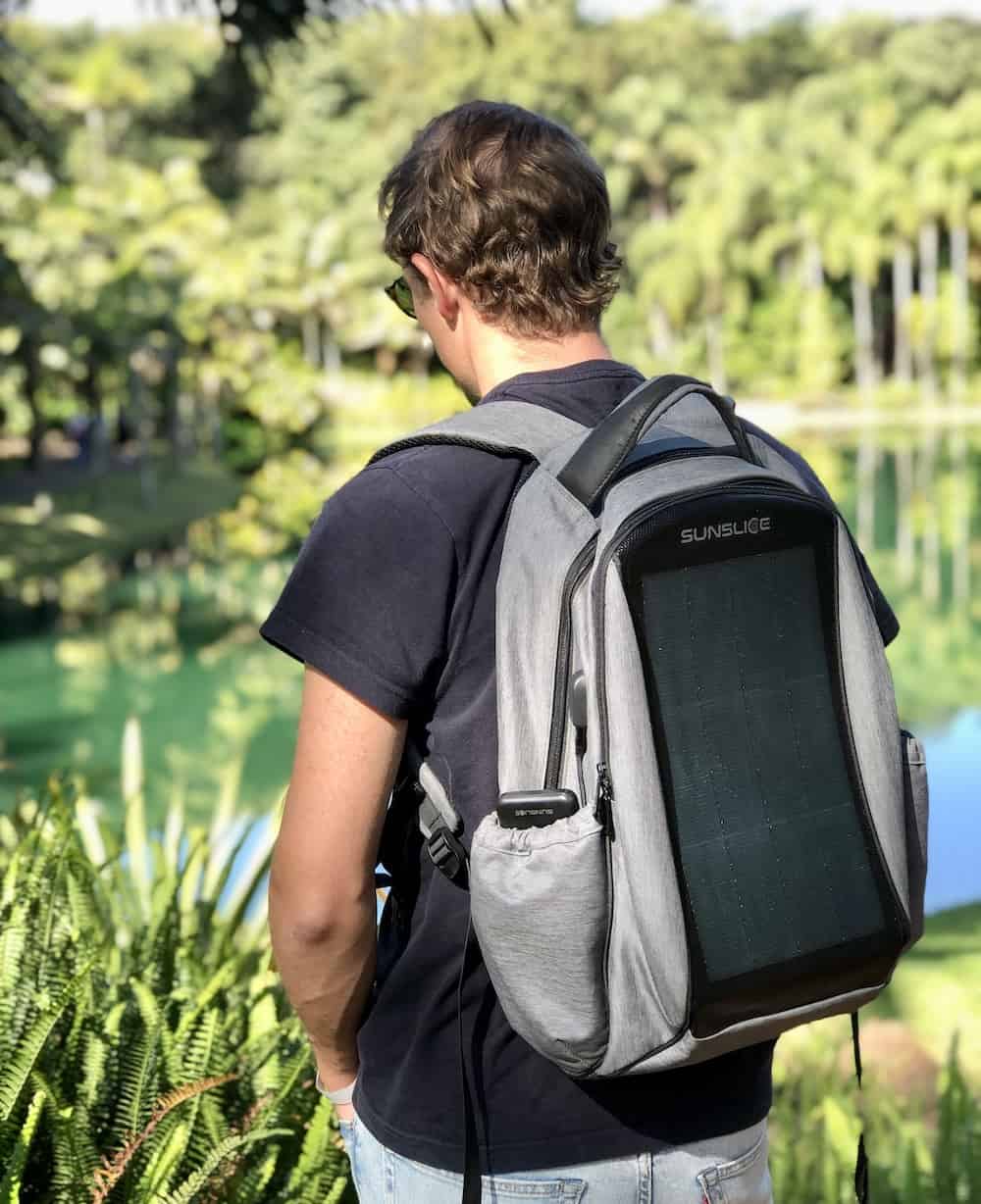 sunslice zenith solar backpack charging a powerbank and worn by a man