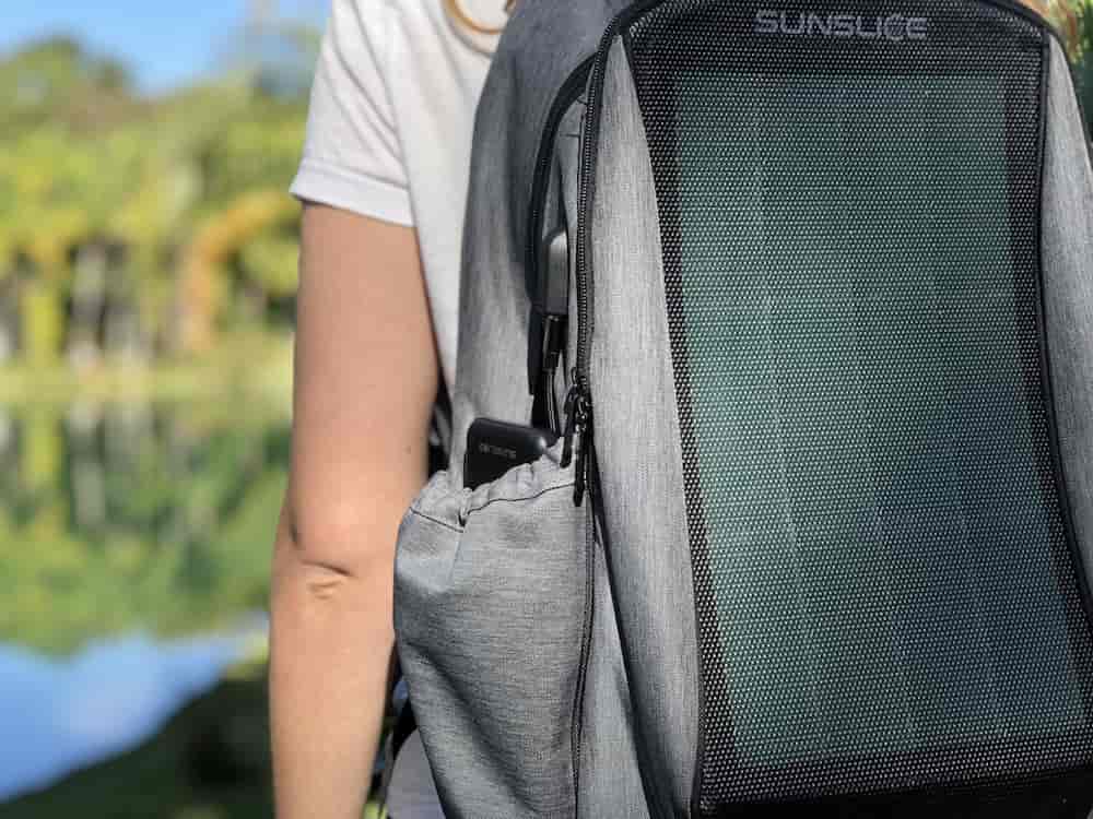 sunslice zenith grey solar backpack worn by a woman