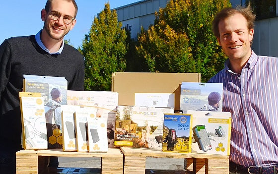 Sunslice founders Henri Gernaey and Geoffroy Ghion with their products such as Fusion Flex portable solar panels, Photon solar chargers, solar generators