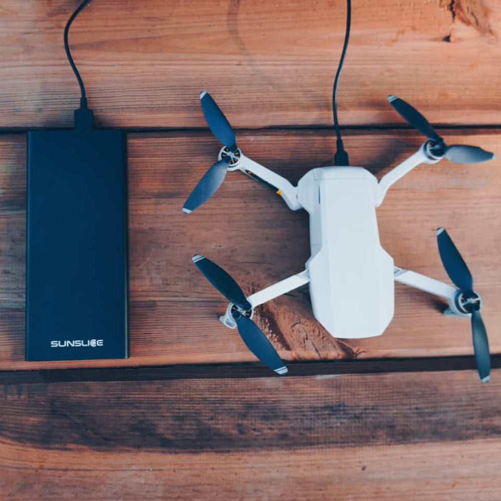 gravity27 portable laptop charger loading a drone from the top