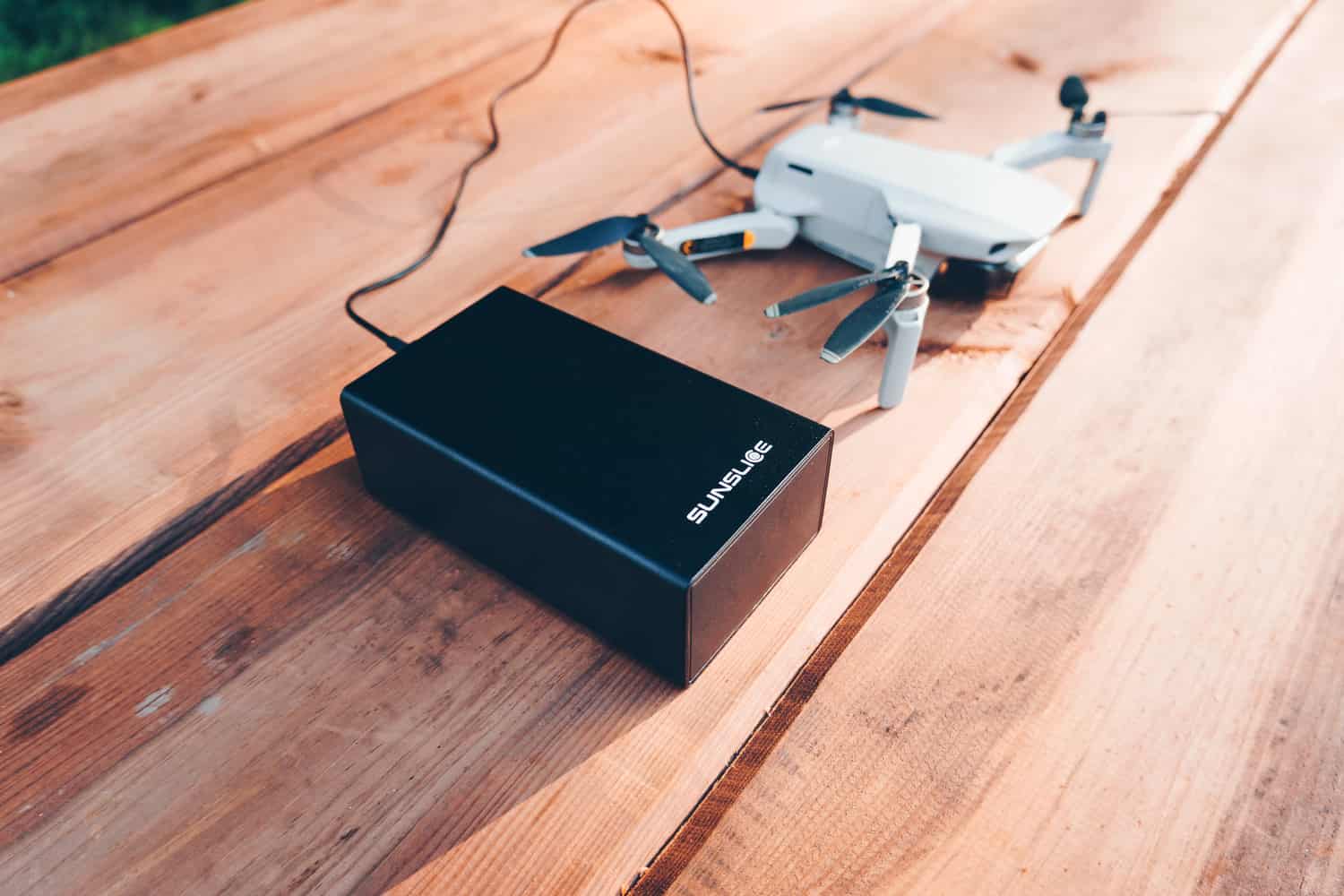 gravity40 external battery 100 w power bank loading a drone on a table