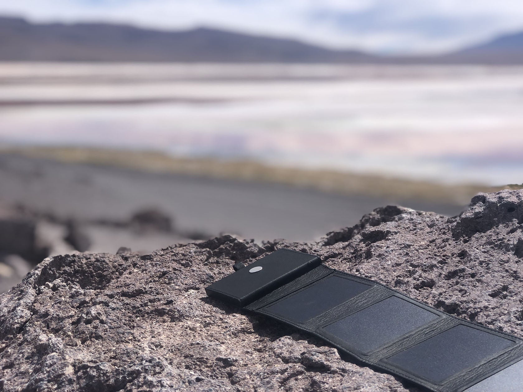 solar power bank (photon) in the sun and on a rock 